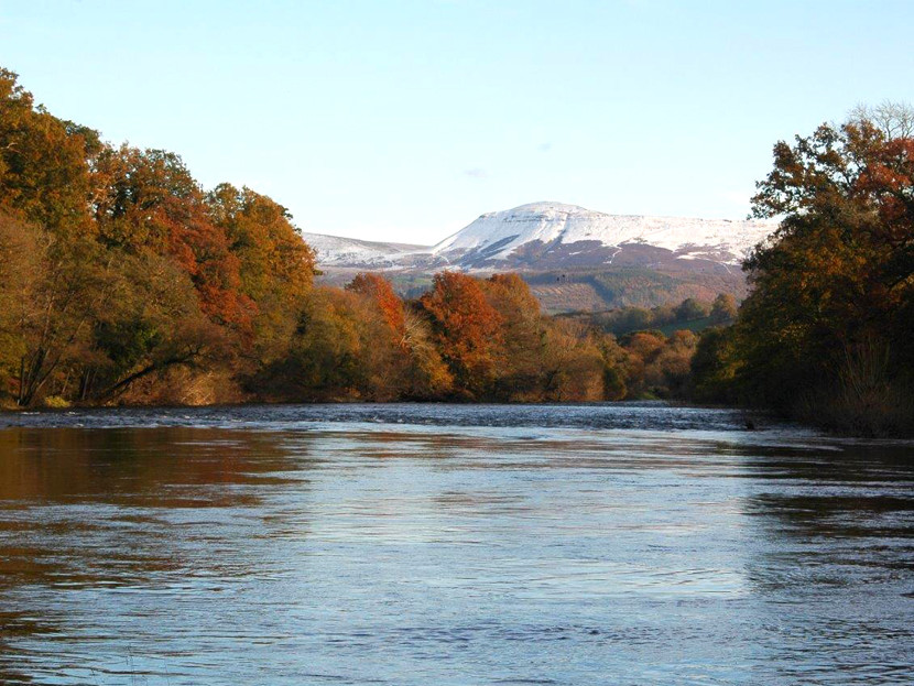 The upper Wye in November with white Black Mountains in the background